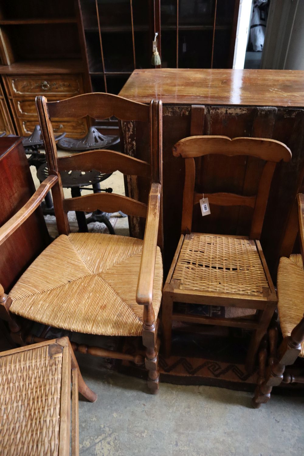 A pair of beech rush seat elbow chairs and a pair of 19th century French fruitwood chairs